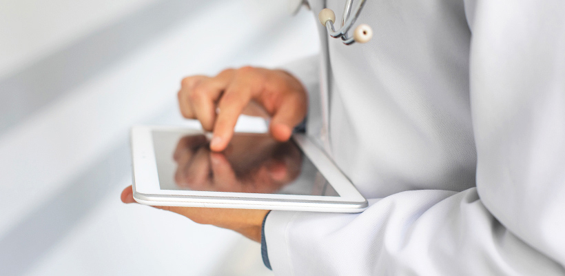 A healthcare worker with a tablet